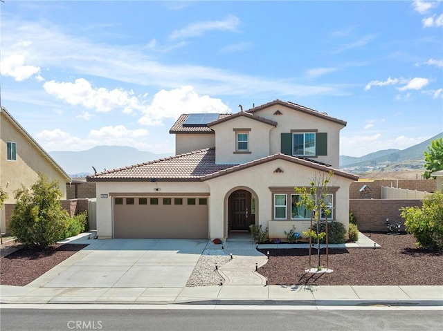 29628 Dotted Mint, Winchester, CA 92596 - mediterranean / spanish-style house featuring a mountain view, an attached garage, stucco siding, and roof mounted solar panels
