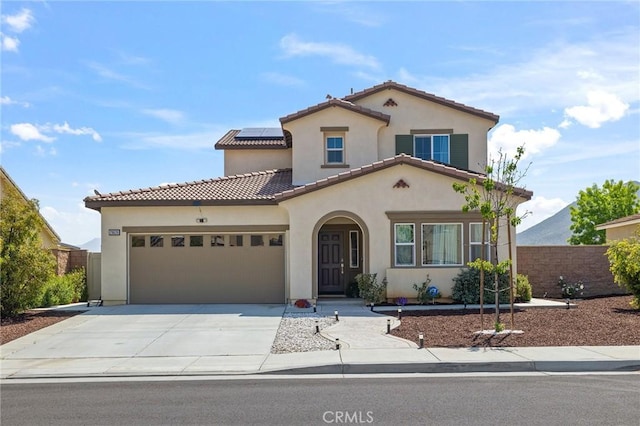 29628 Dotted Mint, Winchester, CA 92596 - mediterranean / spanish-style house featuring a garage, stucco siding, solar panels, fence, and driveway