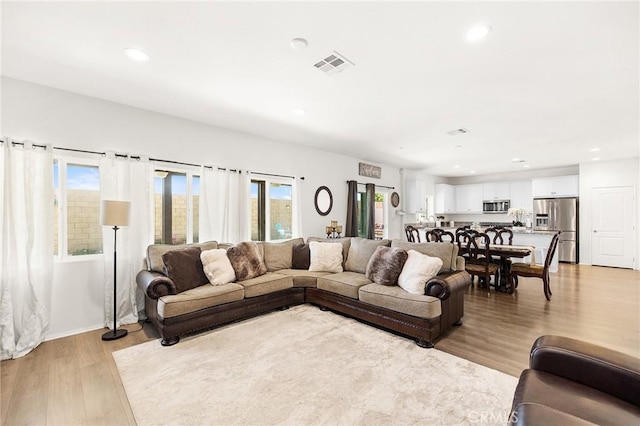 29628 Dotted Mint, Winchester, CA 92596 - living room featuring light wood-type flooring, recessed lighting, and baseboards
