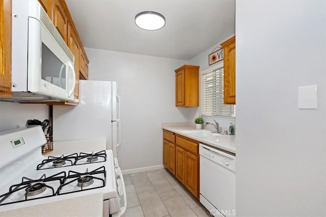 8990 19th St Unit 383, Rancho Cucamonga, CA 91701 - kitchen with white appliances, light countertops, a sink, baseboards, and brown cabinets