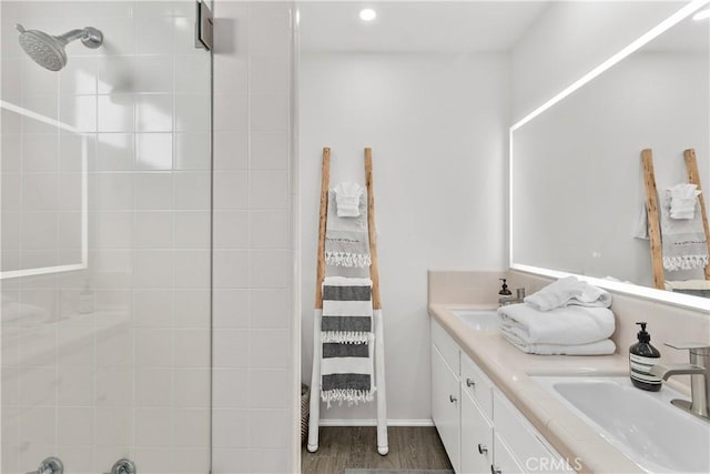 35581 Beach Rd, Dana Point, CA 92624 - full bath with a tile shower, double vanity, wood finished floors, recessed lighting, and baseboards