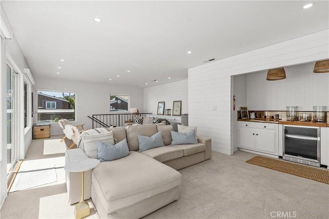 35581 Beach Rd, Dana Point, CA 92624 - living area featuring beverage cooler, bar area, light colored carpet, recessed lighting, and wood walls