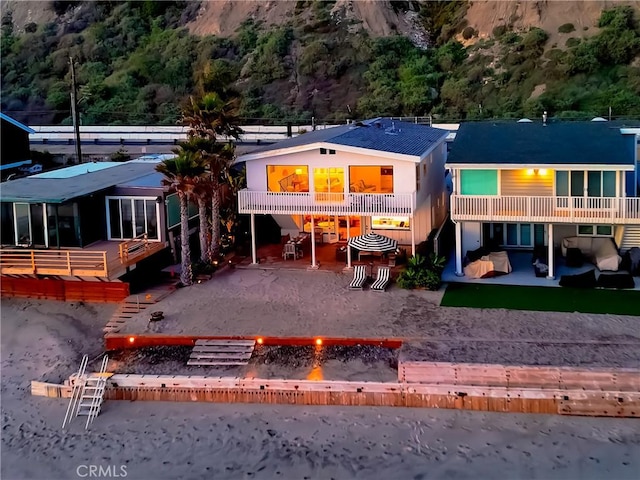 35581 Beach Rd, Dana Point, CA 92624 - back of house featuring an outdoor fire pit, a patio area, a forest view, and a balcony