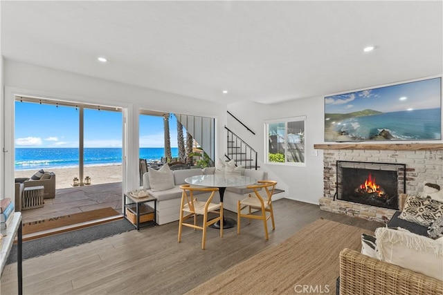 35581 Beach Rd, Dana Point, CA 92624 - dining room with stairway, wood finished floors, a lit fireplace, and recessed lighting