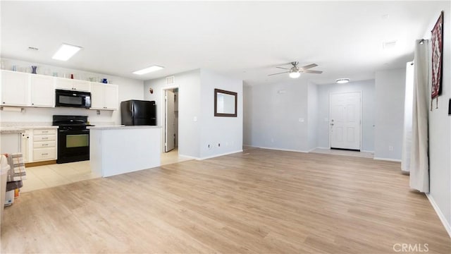 3261 James Ct, Lancaster, CA 93535 - kitchen with black appliances, light wood finished floors, a ceiling fan, and white cabinets