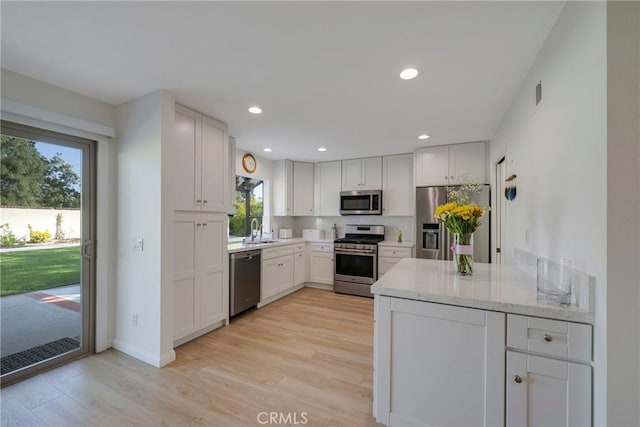 5110 Via Donaldo, Yorba Linda, CA 92886 - kitchen featuring appliances with stainless steel finishes, a sink, light wood-type flooring, white cabinets, and recessed lighting