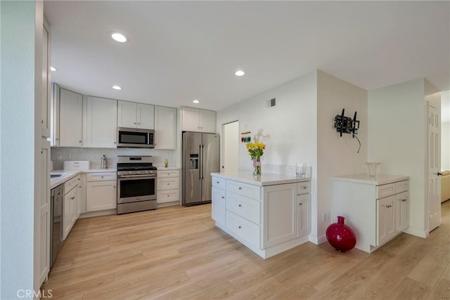 5110 Via Donaldo, Yorba Linda, CA 92886 - kitchen featuring appliances with stainless steel finishes, light wood-style floors, light countertops, recessed lighting, and decorative backsplash