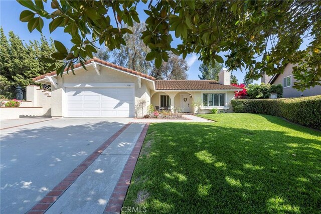 5110 Via Donaldo, Yorba Linda, CA 92886 - mediterranean / spanish-style home featuring stucco siding, a front yard, a tiled roof, driveway, and a garage