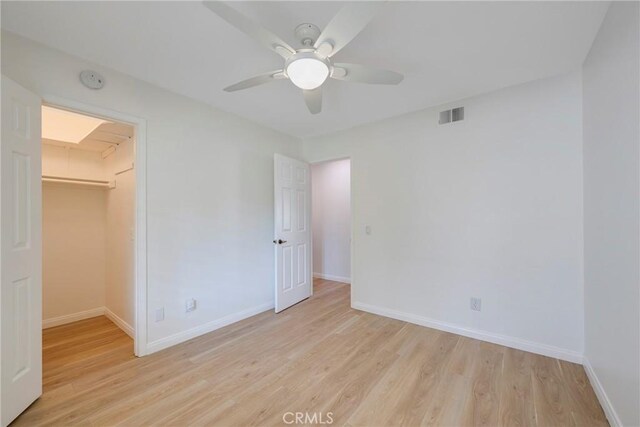 5110 Via Donaldo, Yorba Linda, CA 92886 - unfurnished bedroom featuring light wood finished floors, a walk in closet, a closet, and ceiling fan