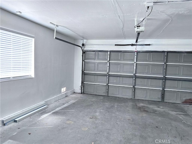 garage with a garage door opener and baseboards