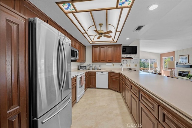23316 Gray Fox Dr, Canyon Lake, CA 92587 - kitchen featuring appliances with stainless steel finishes, a ceiling fan, light countertops, open floor plan, and light floors