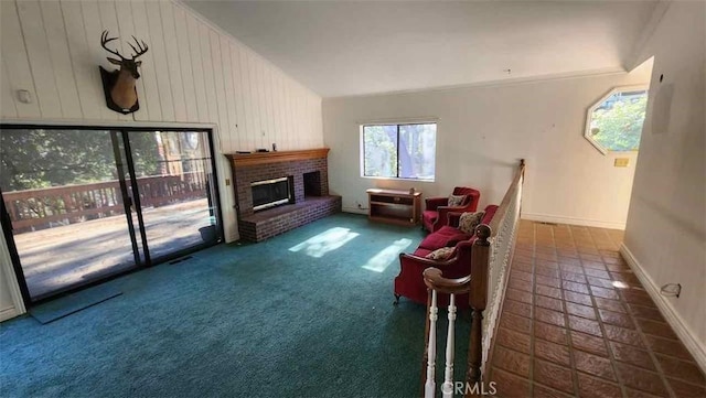 living area with baseboards, a fireplace, and lofted ceiling