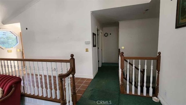 corridor featuring an upstairs landing and baseboards
