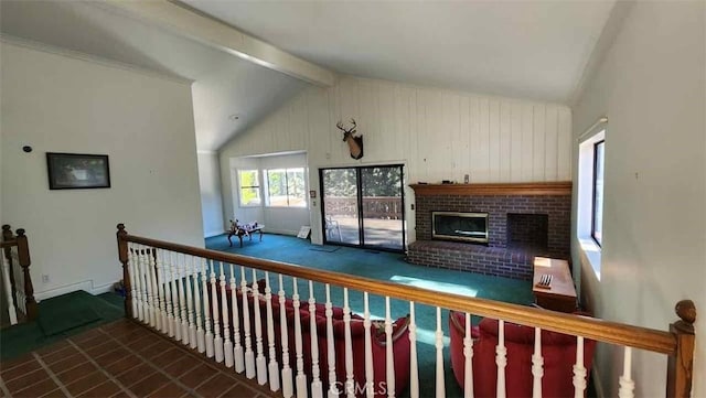 living area featuring a brick fireplace, baseboards, and carpet