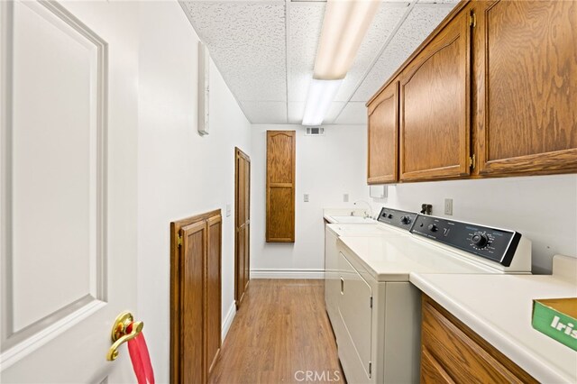 179 Chippewa Ln, Lake Arrowhead, CA 92352 - laundry room featuring cabinet space, separate washer and dryer, light wood-style flooring, and baseboards