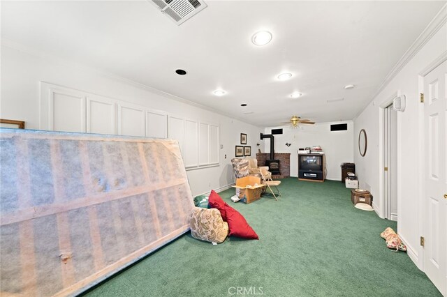 179 Chippewa Ln, Lake Arrowhead, CA 92352 - playroom featuring a wood stove, carpet flooring, ornamental molding, baseboards, and recessed lighting