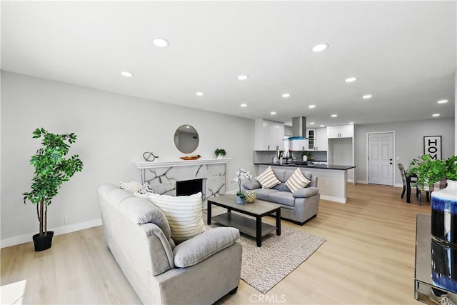 1608 E Helmick St, Carson, CA 90746 - living area with light wood-type flooring, recessed lighting, baseboards, and a premium fireplace