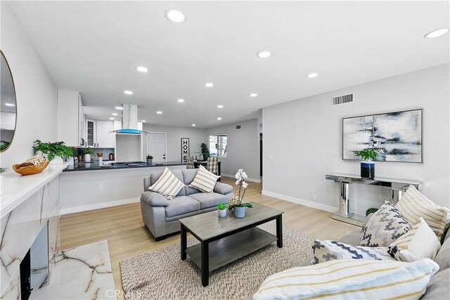 1608 E Helmick St, Carson, CA 90746 - living area with recessed lighting, light wood-style flooring, and baseboards