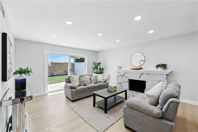 1608 E Helmick St, Carson, CA 90746 - living area featuring light wood-style floors, recessed lighting, baseboards, and a high end fireplace