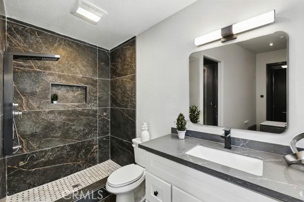 1608 E Helmick St, Carson, CA 90746 - full bath with toilet, a tile shower, and vanity