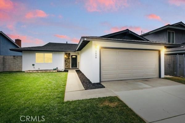 1608 E Helmick St, Carson, CA 90746 - ranch-style home featuring an attached garage, concrete driveway, and stucco siding