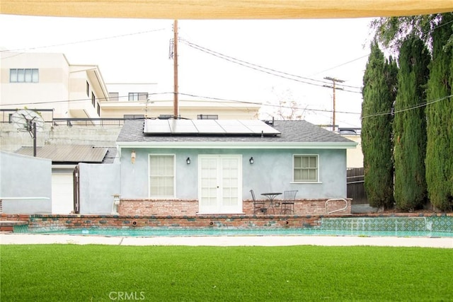2619 Mary St, La Crescenta, CA 91214 - back of house featuring stucco siding, solar panels, a shingled roof, french doors, and a lawn