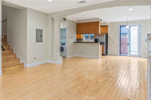 66 N Allen Ave Unit 3, Pasadena, CA 91106 - unfurnished living room featuring electric panel, washer / dryer, crown molding, light wood-type flooring, and baseboards