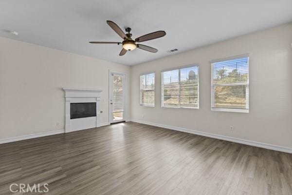341 Caldera St, Perris, CA 92570 - unfurnished living room featuring wood finished floors, ceiling fan, a glass covered fireplace, and baseboards