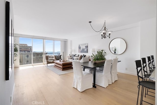 850 E Ocean Blvd Unit 602, Long Beach, CA 90802 - dining area featuring light wood-style flooring, a chandelier, and expansive windows