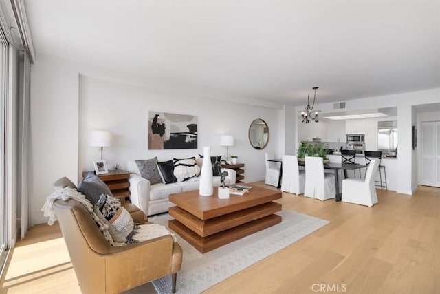 850 E Ocean Blvd Unit 602, Long Beach, CA 90802 - living room with light wood-style floors and a chandelier