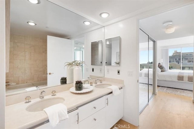 850 E Ocean Blvd Unit 602, Long Beach, CA 90802 - bathroom featuring double vanity, connected bathroom, recessed lighting, wood finished floors, and a tub to relax in