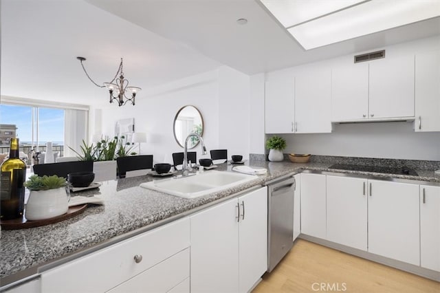 850 E Ocean Blvd Unit 602, Long Beach, CA 90802 - kitchen with dishwasher, white cabinetry, black electric stovetop, stone countertops, and a chandelier