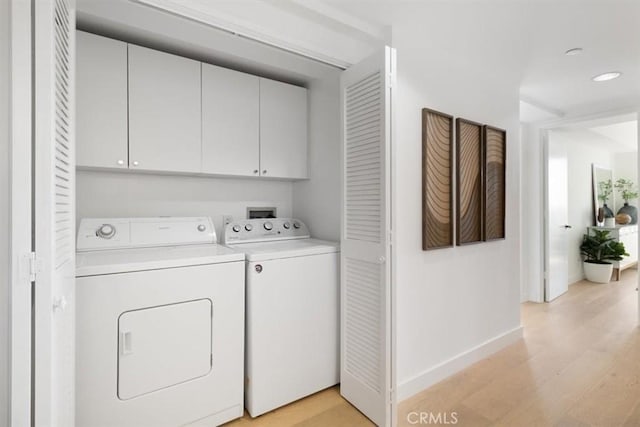 850 E Ocean Blvd Unit 602, Long Beach, CA 90802 - washroom with cabinet space, washing machine and dryer, and light wood-type flooring