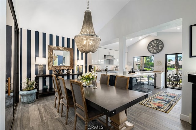 dining area featuring wood finished floors, high vaulted ceiling, and recessed lighting