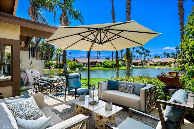 view of patio with an outdoor living space, a water view, outdoor dining space, grilling area, and a residential view