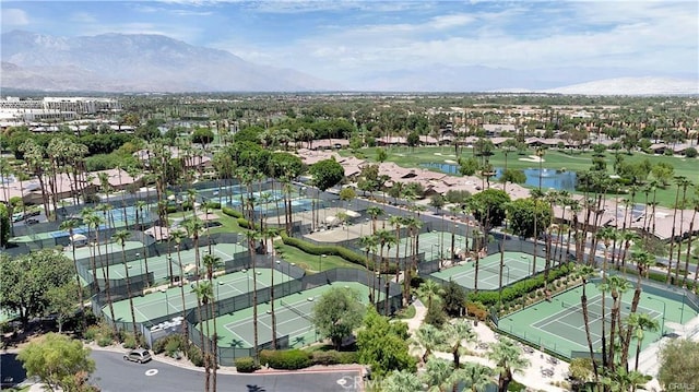 aerial view of property and surrounding area with a water and mountain view and nearby suburban area
