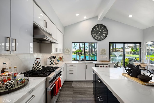 kitchen with stainless steel range, under cabinet range hood, beamed ceiling, white cabinets, and tasteful backsplash