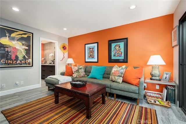 living area featuring recessed lighting, baseboards, and wood finished floors
