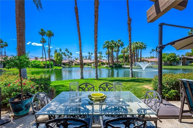 view of patio featuring a water view and outdoor dining space