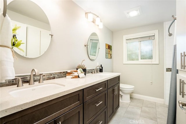 17301 Elsinore Cir, Huntington Beach, CA 92647 - full bathroom with toilet, double vanity, baseboards, and tasteful backsplash