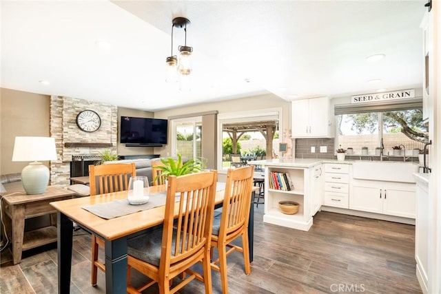 17301 Elsinore Cir, Huntington Beach, CA 92647 - dining room featuring a stone fireplace, dark wood-style floors, and recessed lighting
