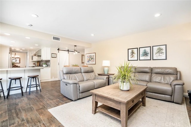 17301 Elsinore Cir, Huntington Beach, CA 92647 - living room with a barn door, recessed lighting, and dark wood finished floors