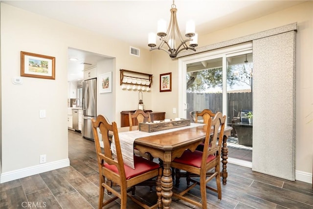 17301 Elsinore Cir, Huntington Beach, CA 92647 - dining space with a chandelier, dark wood-type flooring, and baseboards
