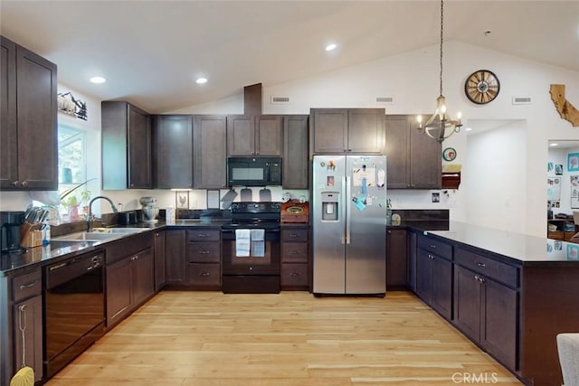 6151 N Libby Rd, Paradise, CA 95969 - kitchen featuring black appliances, a sink, a peninsula, dark countertops, and a chandelier