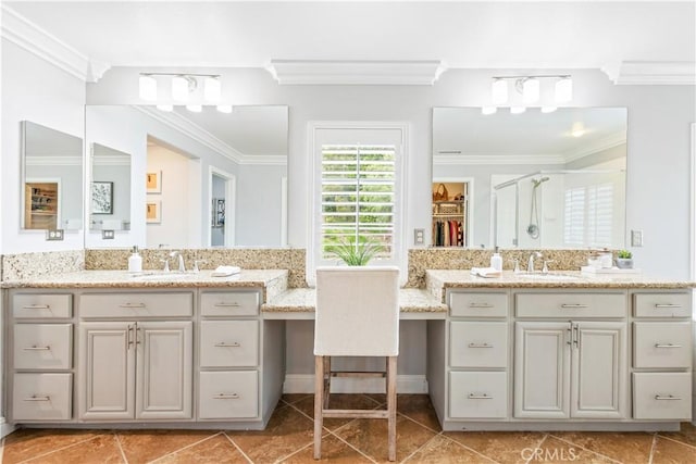 bathroom featuring a shower stall, ornamental molding, two vanities, and tile patterned flooring