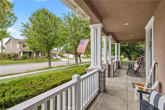 view of patio featuring a porch and a residential view