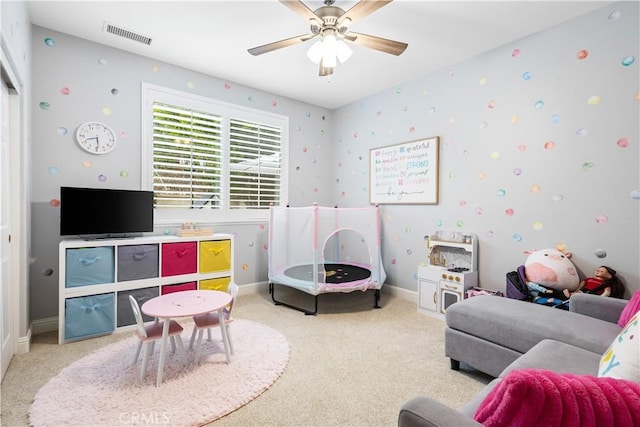 playroom featuring carpet, ceiling fan, and baseboards