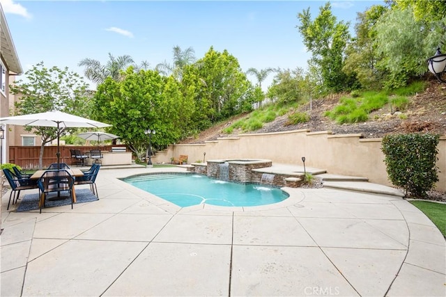 view of swimming pool with an in-ground hot tub, a patio area, and fence