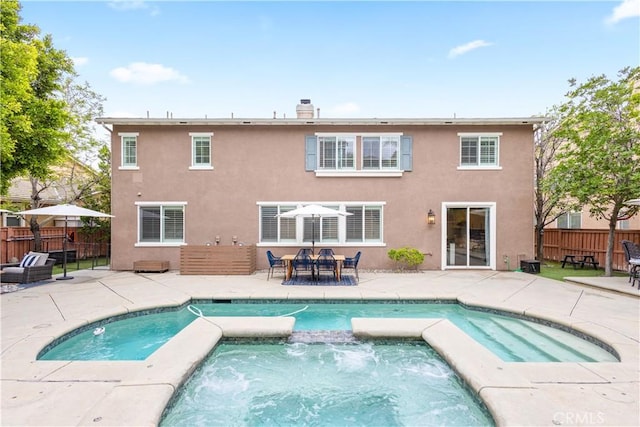 back of property with a patio area and fence