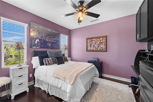 7051 Sitio Caliente, Carlsbad, CA 92009 - bedroom featuring baseboards, multiple windows, dark wood-style flooring, and ceiling fan